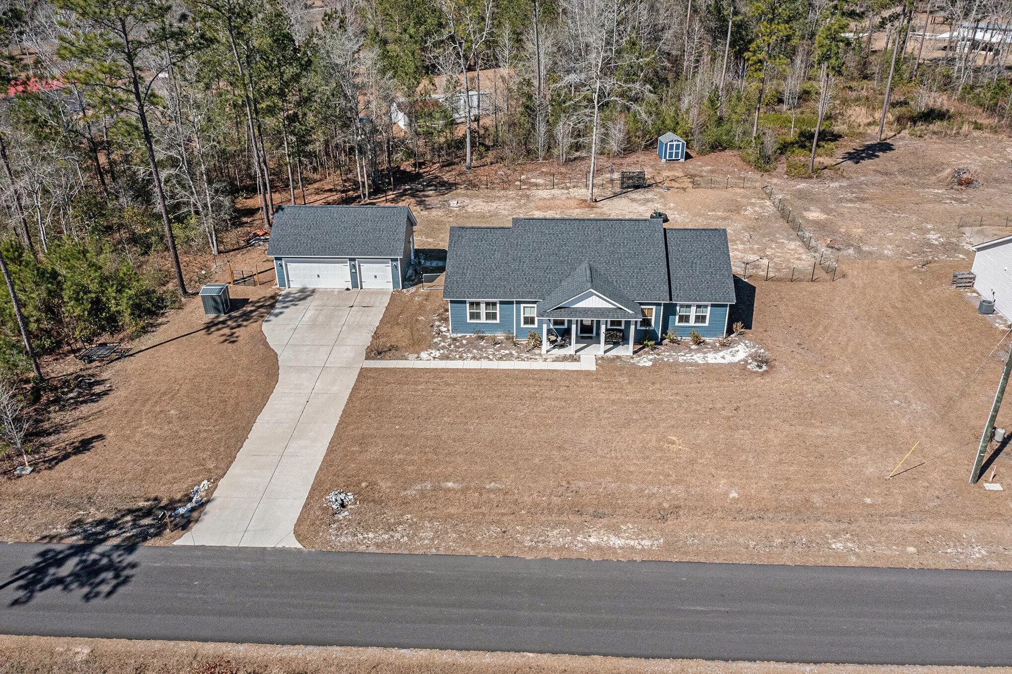 Aerial over the full one-acre lot, house and detached garage